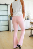 Feminine Flair Mid Rise Distressed Flares in Pastel Pink